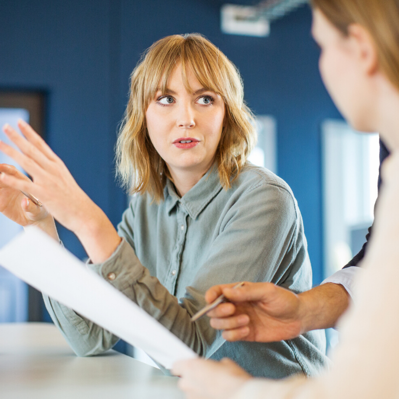 Woman explaining something to colleagues
